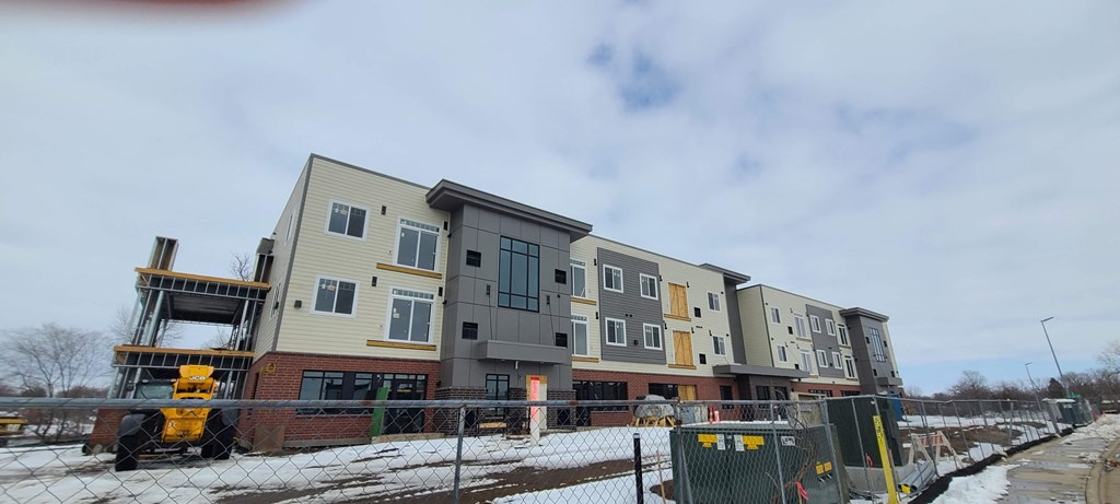 a row of apartment buildings under construction in the snow