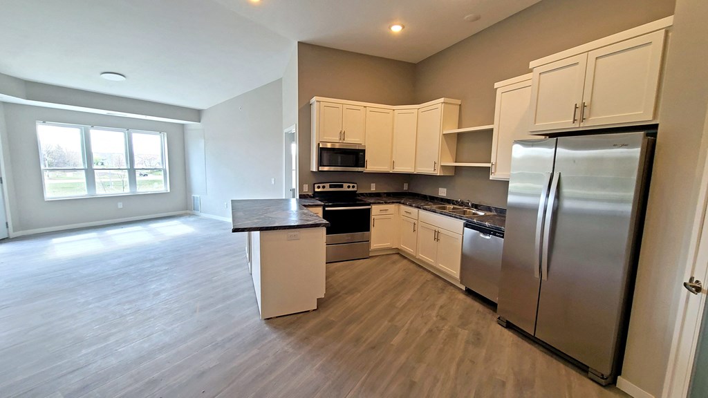 a kitchen with stainless steel appliances and white cabinets