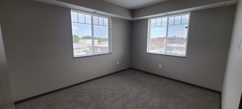 an empty room with three windows