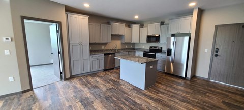 a kitchen with white cabinets and a counter top