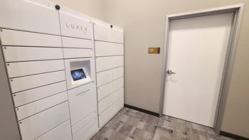 a white locker room with a white door and a door to the luckier room