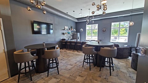 a dining room with tables and chairs and a tv in the corner