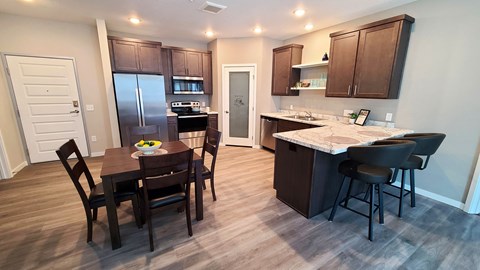 a kitchen and dining area with a table and chairs