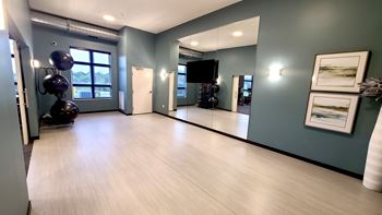 an empty room with paintings on the wall and a wooden floor