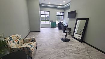 a living room with a couch and a mirror on the wall