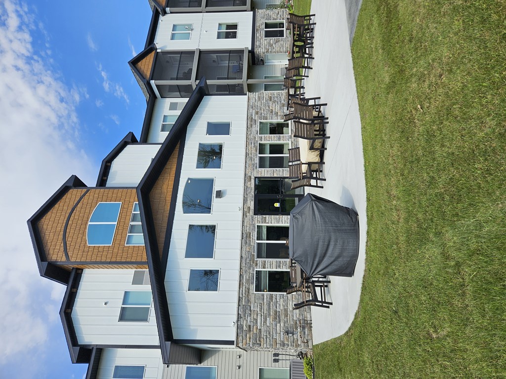 A modern house with a curved roof and a balcony.