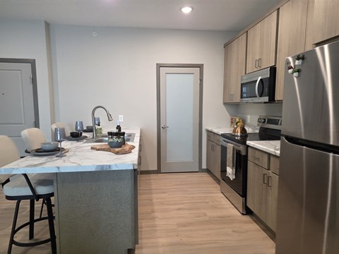 A kitchen with a table and chairs.