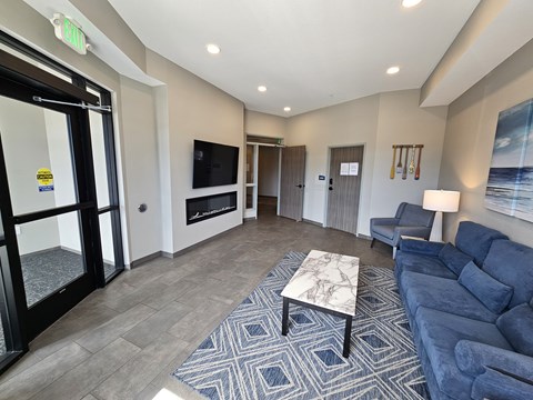 A living room with a blue couch and a television.