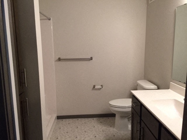 a bathroom with a toilet and a sink and a shower