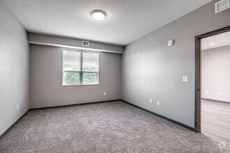 an empty room with a window and a door