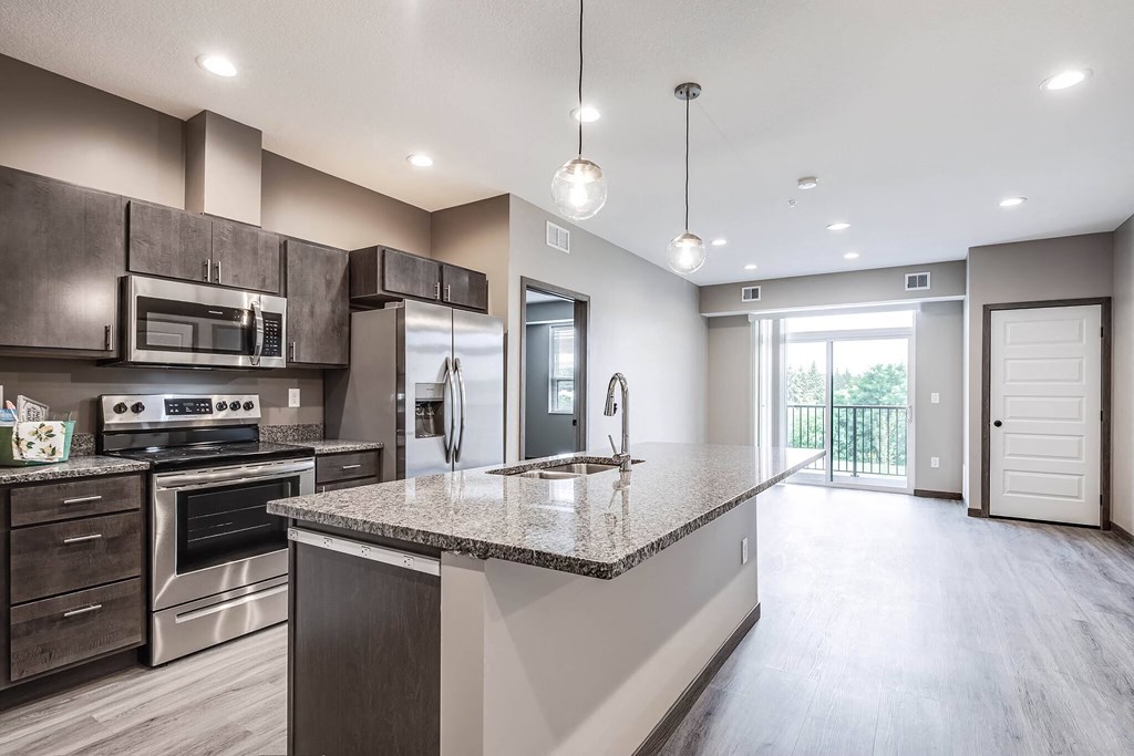 a kitchen with stainless steel appliances and a granite counter top