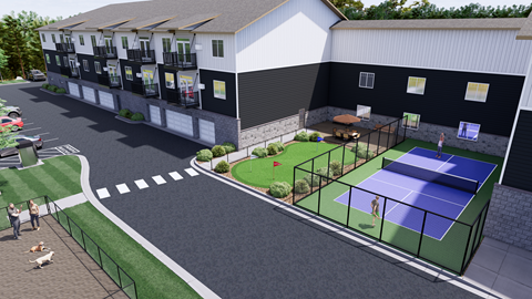 A tennis court is located in front of a white building.