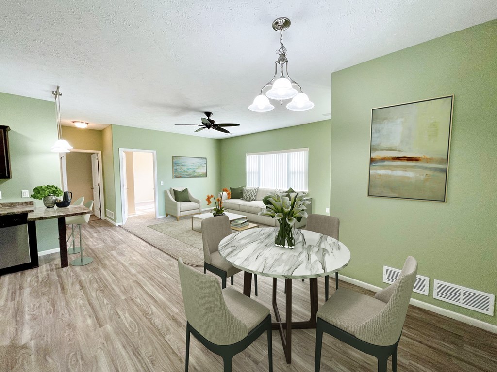 a living room and dining room with a table and chairs