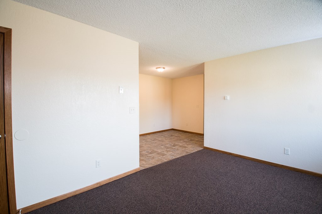 A room with carpeted floor and white walls.