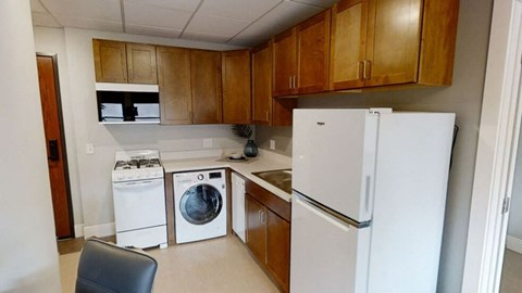 a kitchen with white appliances and wooden cabinets