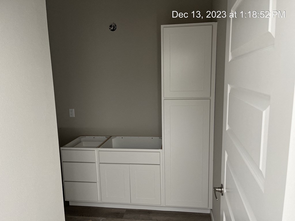 the interior of a room with white cabinets and a sink