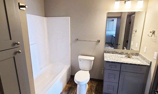 a bathroom with a toilet and a sink and a bath tub