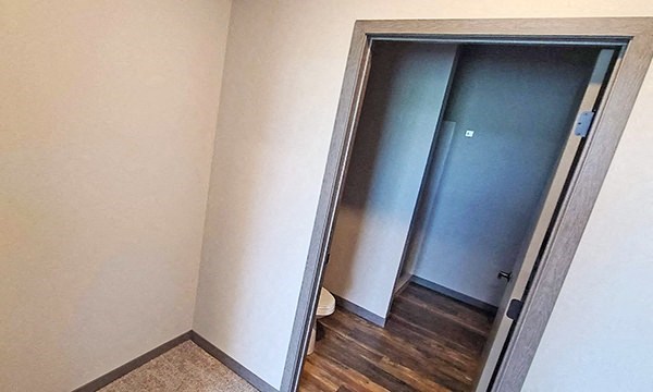 an empty room with a door to a closet