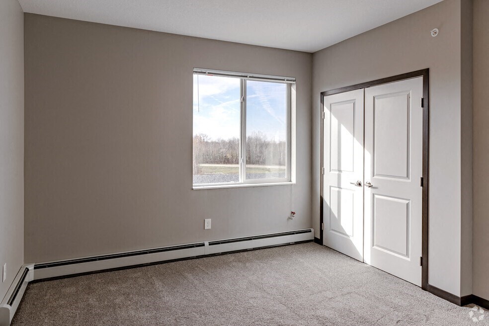 an empty room with a door and a window