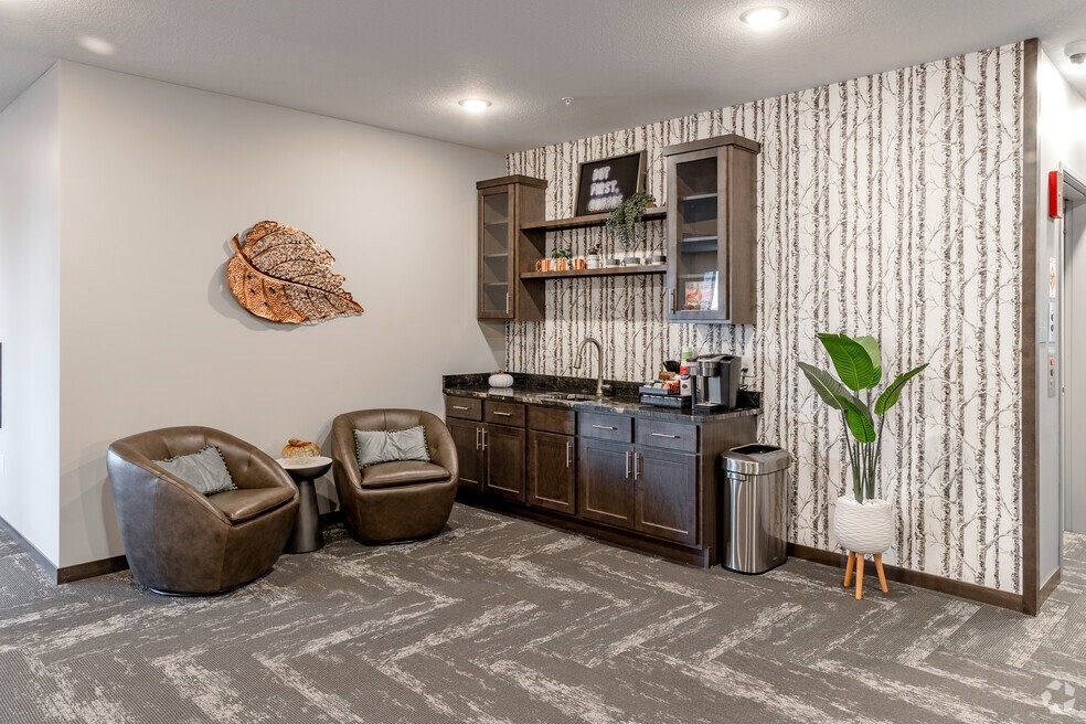 the living room of a home with a counter and chairs