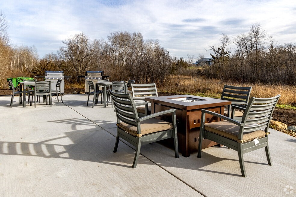 a patio with chairs and a table on a patio