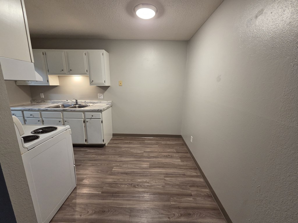 A small kitchen with a washer and dryer.