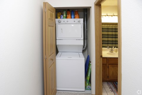 A small kitchen with a white fridge and a white washing machine.