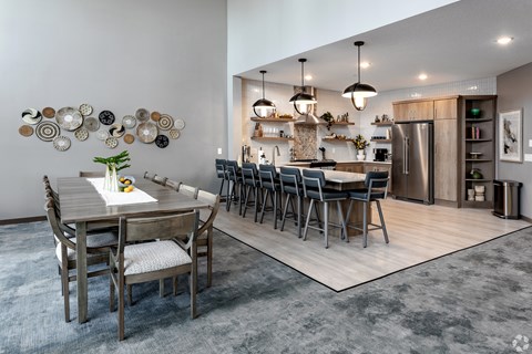 A modern kitchen with a dining table and chairs.