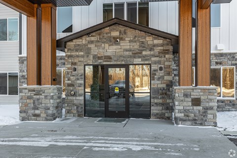 A building with a stone facade and a black door.