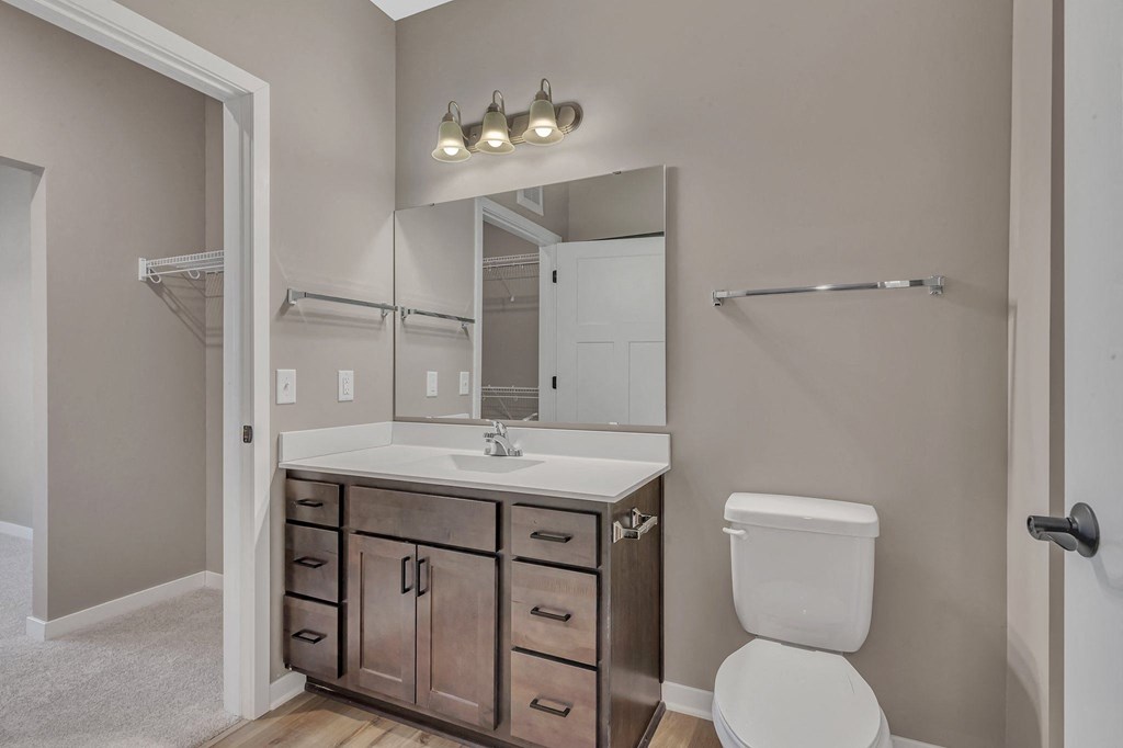 A white toilet sits next to a sink in a bathroom.