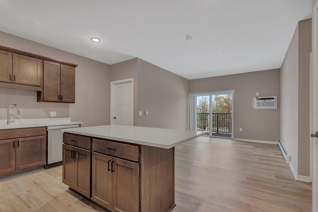 A kitchen with wooden cabinets and a white countertop.