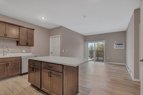 A kitchen with wooden cabinets and a white countertop.