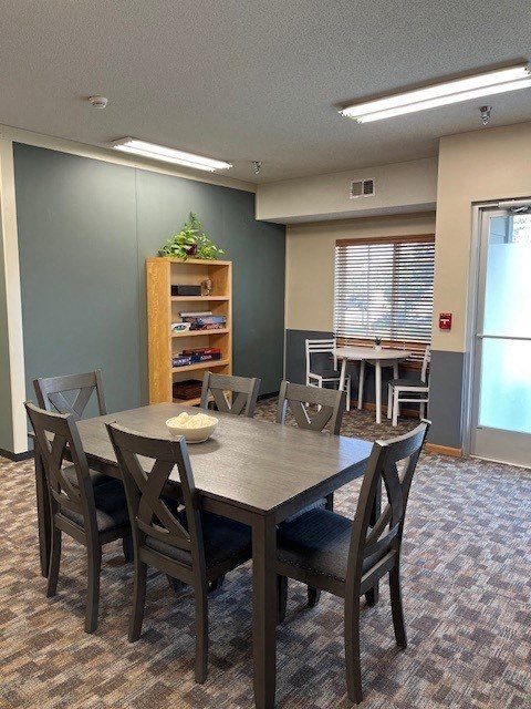 a dining room with a table and chairs