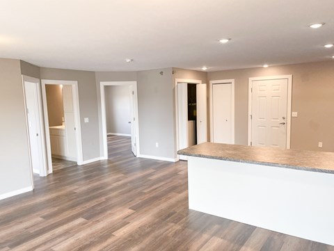 A spacious room with a reception desk and multiple doors.