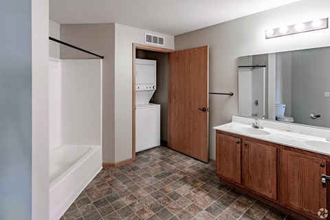 a bathroom with a sink and a tub and a shower and a mirror