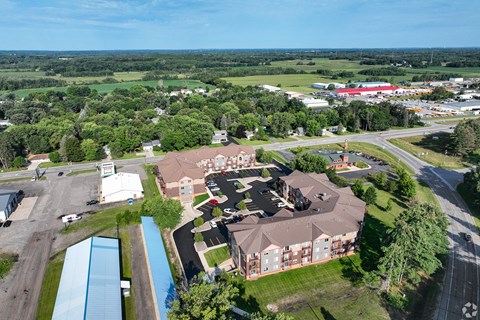 an aerial view of a large estate with houses and a parking lot