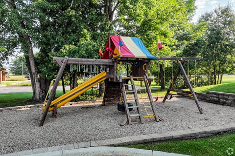 a swing set on the playground in a park