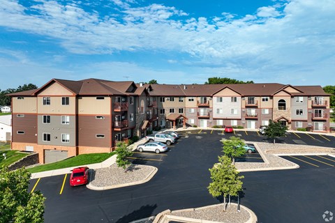 an aerial view of an apartment building in a parking lot