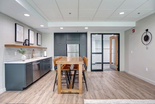 A modern kitchen with a dining table and chairs.