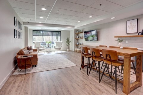 A modern living room with a wooden dining table and chairs.