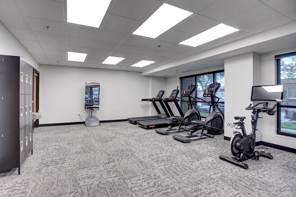 A gym room with treadmills and exercise bikes.