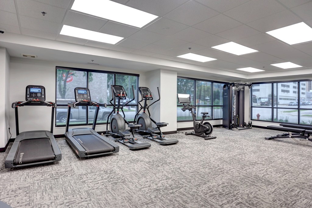 A gym with treadmills, elliptical machines, and other exercise equipment.