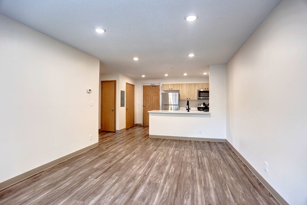 A room with wooden floors and white walls.
