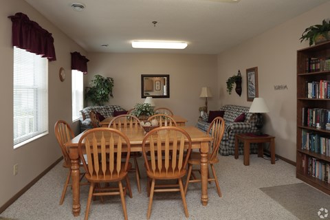 a dining room with a table and chairs and a living room with couches