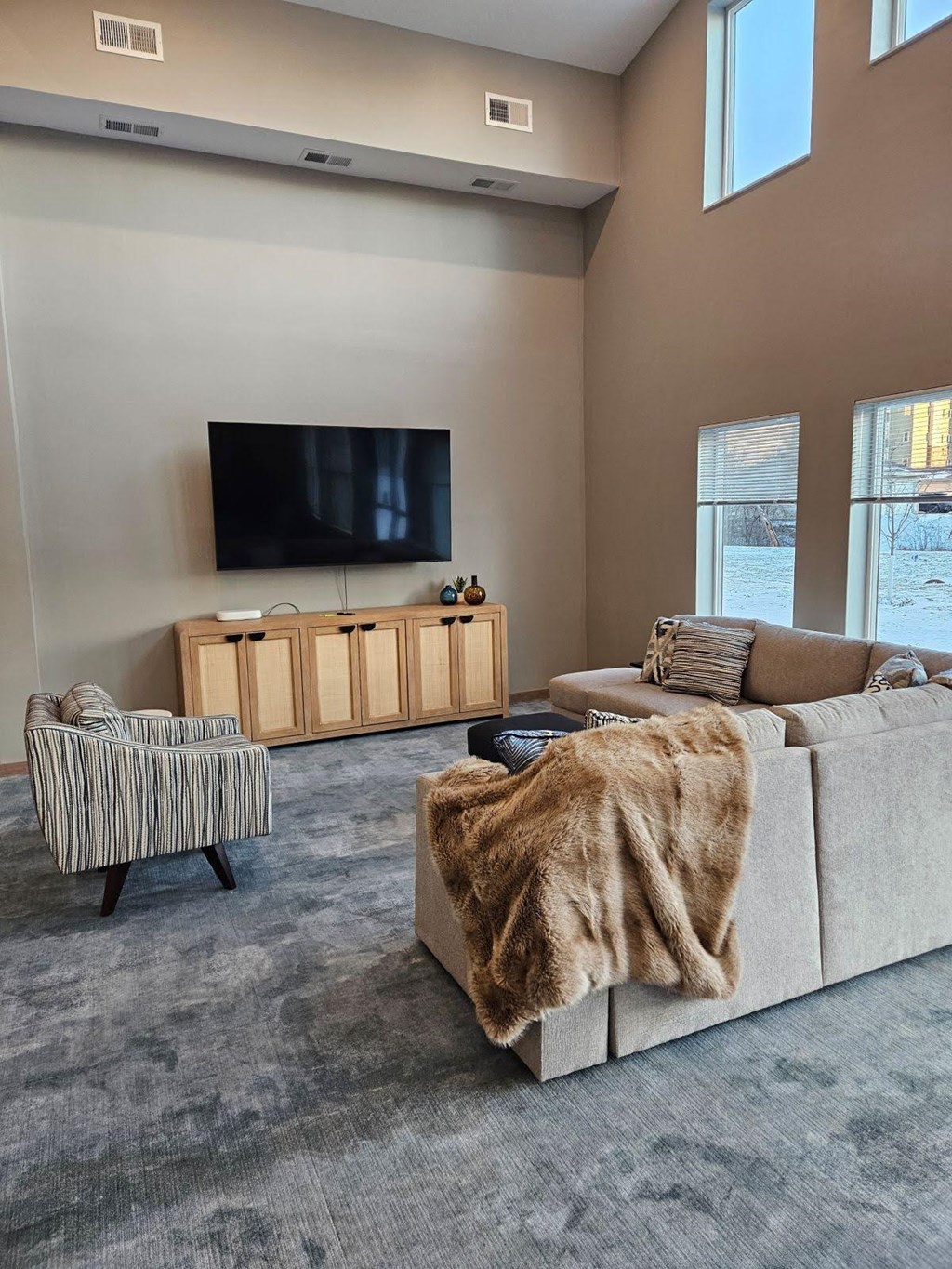 A living room with a large couch and a television.