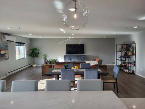 A modern living room with a grey sofa and a television.