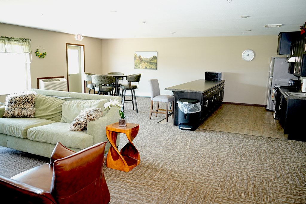 A living room with a couch, chairs, and a coffee table.