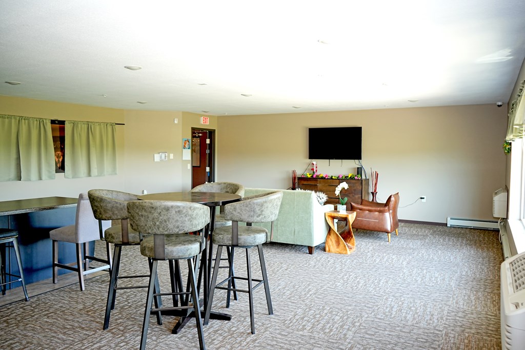 A room with a table and chairs in it.