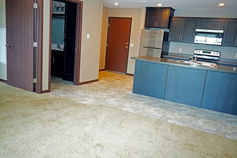 A kitchen with a blue counter and a brown door.