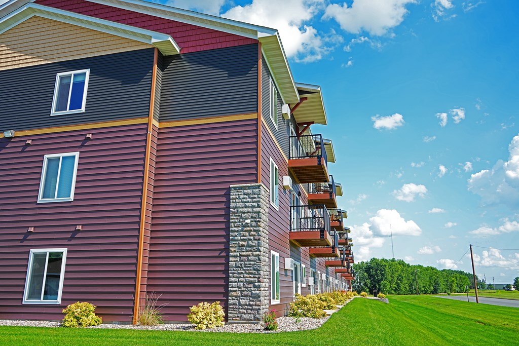 A red building with a balcony on the second floor.